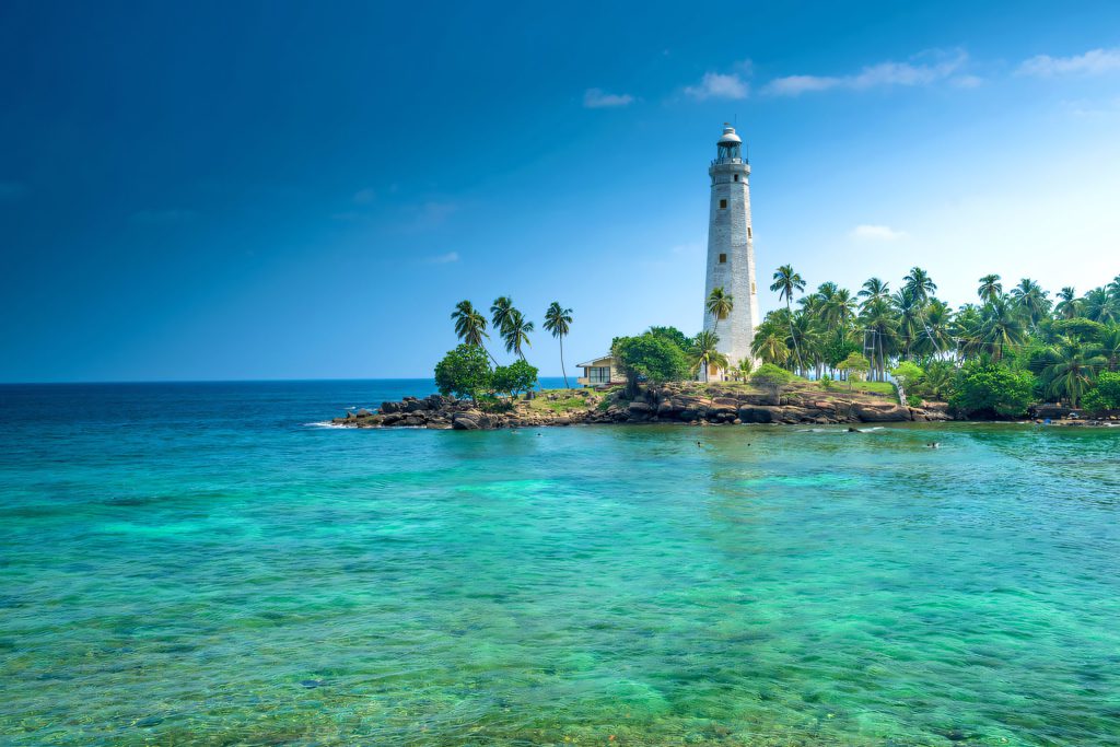 Lighthouse over turquoise water on the south coast