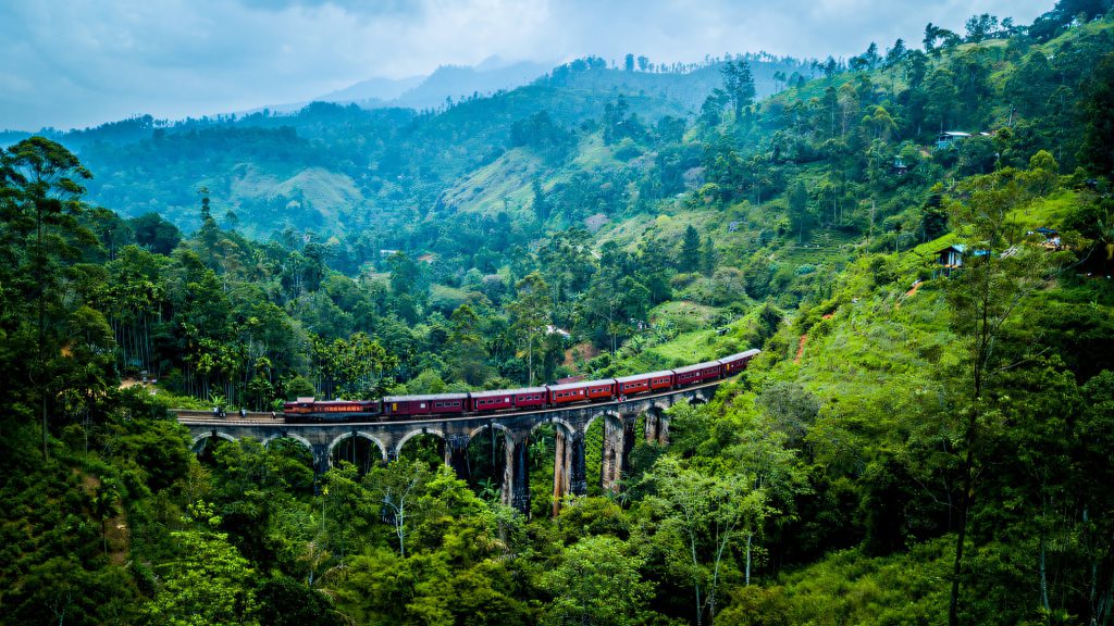 Train crossing a green valley